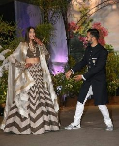 Anand Ahuja in white sneakers on his reception