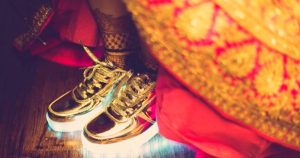 Brides wearing sneakers with lehnga