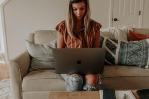 A woman works at home using self-service portals for enhanced customer experience.